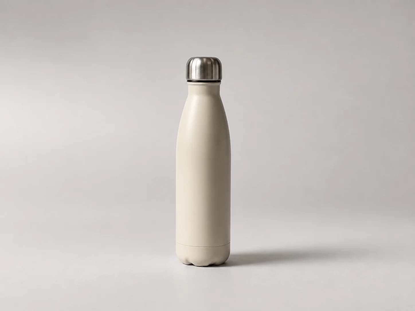 Cream bottle unchanged on a pale seamless studio background